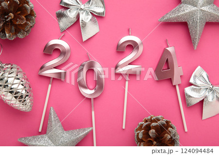 2024 Happy New Year and silver Christmas decoration on pink background. 2024 Happy New Year and silver Christmas decoration on pink background. 124094484