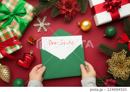 Christmas letter from a child to Santa Claus with the words: Dear Santa. Christmas composition with yellow and green toys. 124094503