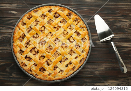 Homemade sweet american apple pie with sugar and cinnamon. Tart on brown background. 124094816