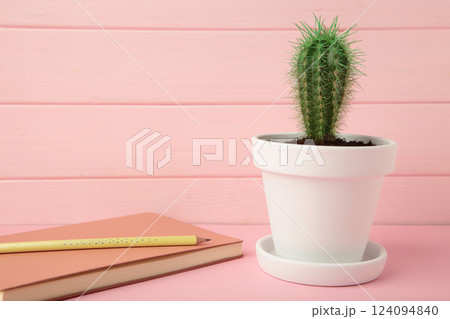 Notepad with small cactus on pink wooden background. Top view 124094840