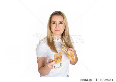 Woman in white t-shirt with dollars in hand. Portrait blonde woman holding money bills. Blond girl holding cash money in euro. Woman holding lots of money in euro currency. Luxury, and money concept. 124096084