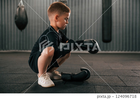 Wearing the glowes. Boy is practicing boxing in the gym Wearing the glowes. Boy is practicing boxing in the gym 124096718