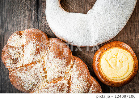 Braided buns bread decorated with sugar above on a wooden table background Braided buns bread decorated with sugar above on a wooden table background 124097106