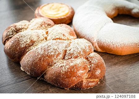 Braided buns bread decorated with sugar above on a wooden table background 124097108