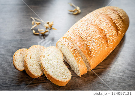 Craft sliced bread on the table at the bakery. The concept of small industries and healthy food Craft sliced bread on the table at the bakery. The concept of small industries and healthy food 124097121
