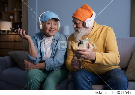 Trendy fashion senior couple using modern gadgets for fun and relax Trendy fashion senior couple using modern gadgets for fun and relax 124098543