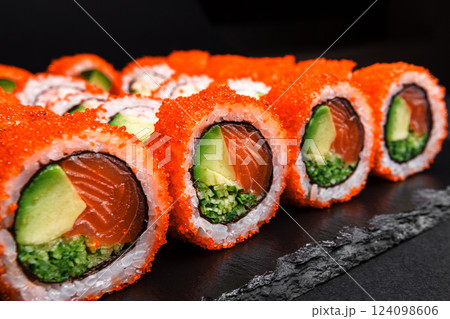 Delicious Fresh Sushi Rolls Set Presenting Exquisitely on a Black Background 124098606