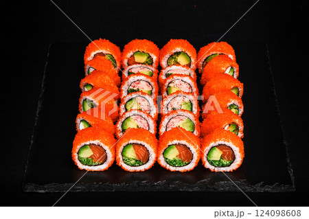 Delicious Fresh Sushi Rolls Set Presenting Exquisitely on a Black Background Delicious Fresh Sushi Rolls Set Presenting Exquisitely on a Black Background 124098608