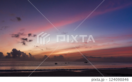 A breathtaking sunset over the tranquil ocean A breathtaking sunset over the tranquil ocean 124098846