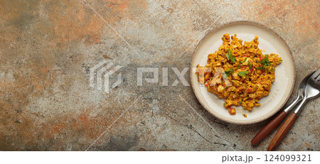 Plate of akuri indian style scrambled eggs with spices and herbs top view with copy space 124099321