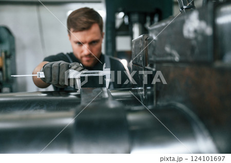 Using measure tool. Man in uniform is in workstation developing details of agriculture technique 124101697