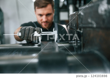 Using measure tool. Man in uniform is in workstation developing details of agriculture technique 124101698