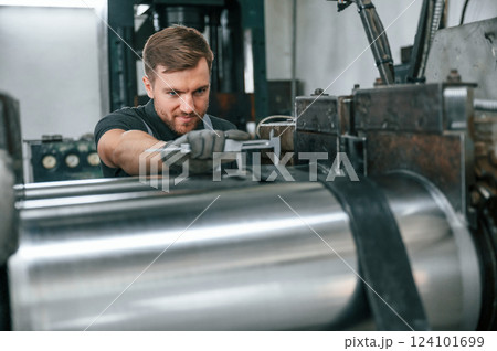 Using measure tool. Man in uniform is in workstation developing details of agriculture technique 124101699