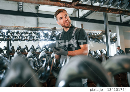 Manager with tablet. Man in uniform is in workstation developing details of agriculture technique 124101754