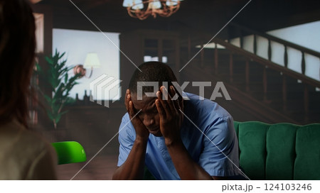 Nurse experiences emotional stress sitting in counseling session, professional deals with mental health issues because of the risks of his occupation. Trauma from patient loss. Camera A. 124103246