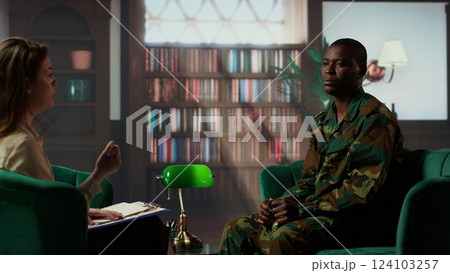 African american war veteran being dissociative and suffers from depersonalization, trying to cure shell shock after bloody combat scenes. Army soldiers experiences derealization condition. Camera B. 124103257