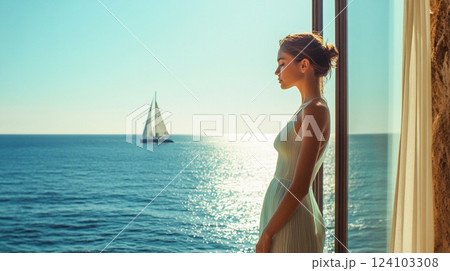 A beautiful thoughtful elegant woman standing near an open window overlooking a calm blue sea in summer. Summertime vacation. Banner for travel agency This is AI-generated item 124103308