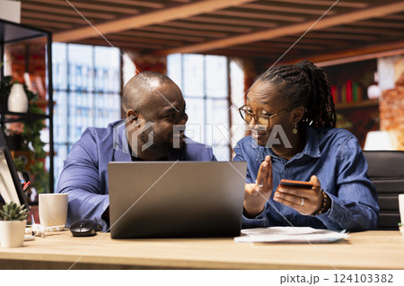 Responsible couple at home office organizing family finances on laptop, tracking joint account expenses by entering card numbers online. Confirming money transfer for their children. Responsible couple at home office organizing family finances on laptop, tracking joint account expenses by entering card numbers online. Confirming money transfer for their children. 124103382