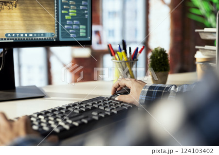 Freelancing architectural designer in home office operating 3D modeling application, importing furniture elements from library, placing them on floor. Close up of man making floor plan in CAD software 124103402