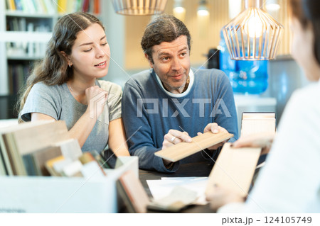Man and woman choosing laminate flooring in the store Man and woman choosing laminate flooring in the store 124105749