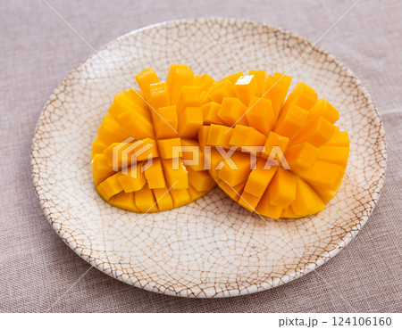 Deliciously served fresh mangoes diced and laid out on plate Deliciously served fresh mangoes diced and laid out on plate 124106160