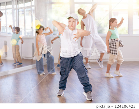 Preteen boy honing hip hop dance moves in choreographic studio Preteen boy honing hip hop dance moves in choreographic studio 124106423