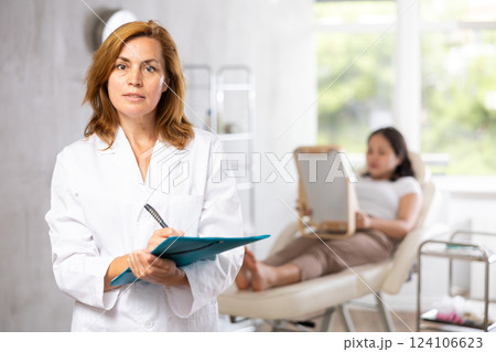 Portrait of middle-aged doctor with documents 124106623
