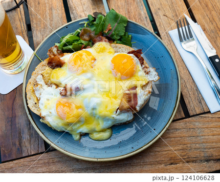 Scrambled eggs with bacon served on plate with greens. Netherlands dish Scrambled eggs with bacon served on plate with greens. Netherlands dish 124106628