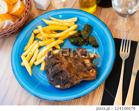 Baked pork knuckle and peppers with French fries 124106676