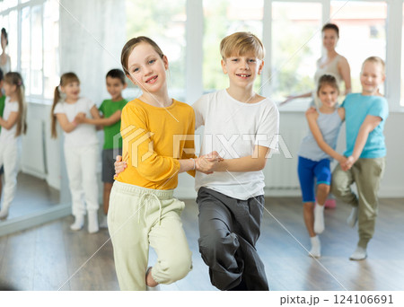 Positive juvenile boy and girl engaged in Rock 'n' Roll dance during dancing classes 124106691