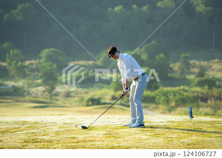 Golfer sport course golf ball fairway.  People lifestyle man approach playing game golf tee off on the green grass. 124106727