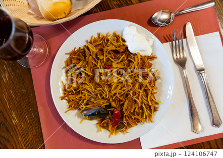 Seafood fideua, savory noodles with fish, squid and clams Seafood fideua, savory noodles with fish, squid and clams 124106747