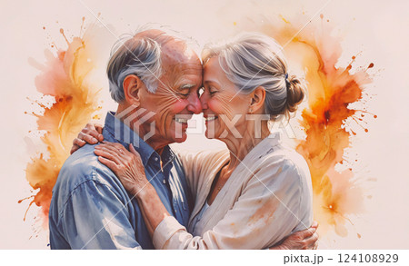 Couple of older people are hugging each other. The man is wearing a blue shirt and the woman is wearing a white shirt. Scene is warm and affectionate 124108929