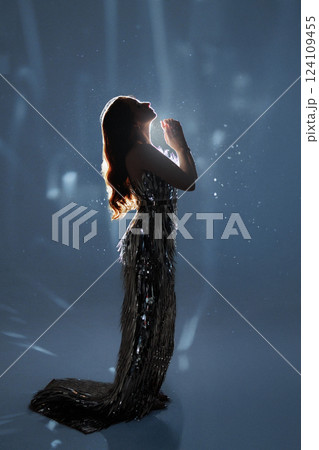 Glamorous Woman in Sparkling Light and Falling Glitter Glamorous Woman in Sparkling Light and Falling Glitter 124109455