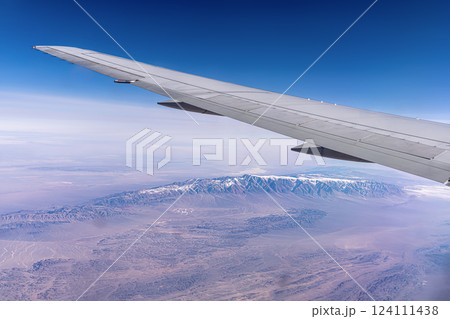 The Kunlun Mountain Range in the Tibetan Plateau in China. View from a high altitude from under the wing of an airplane from the window 124111438
