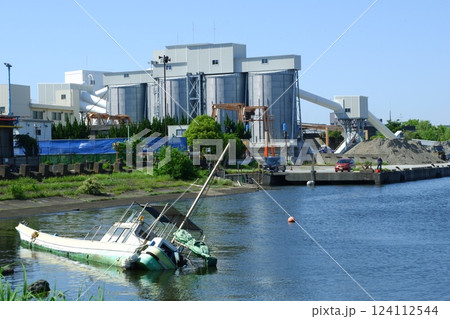 転覆した小型船と千鳥運河沿いの工業地帯 124112544