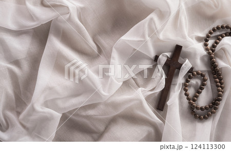 Good Friday and Holy week concept - A religious cross on white fabric background. Good Friday and Holy week concept - A religious cross on white fabric background. 124113300