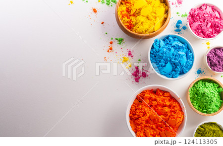 Happy Holi decoration, the indian festival.Top view of colorful holi powder on white background. Happy Holi decoration, the indian festival.Top view of colorful holi powder on white background. 124113305