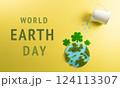 World environment day, earth day, save earth and eco concept. Concept of watering handmade globe from grass and paper on yellow background. 124113307