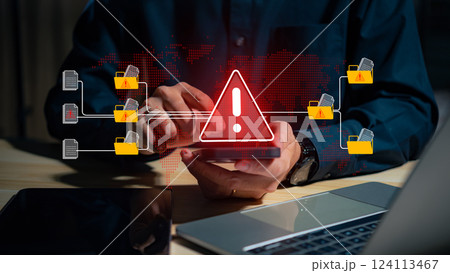 A warning alert icon signals a hacked document system as a man types on a keyboard, surrounded by digital files and documents, with a red cybersecurity threat alert prominent in the scene. 124113467
