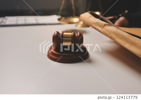 Judge gavel with Justice lawyers having team meeting at law firm background. Concepts of Law and Legal services. 124113779