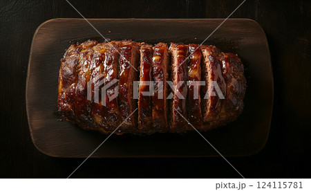 Golden-Brown Glazed Meatloaf on Dark Wooden Board 124115781