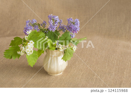 Happy Mother's day concept; bouquet of purple lilac flowers in vase on a burlap background Happy Mother's day concept; bouquet of purple lilac flowers in vase on a burlap background 124115988