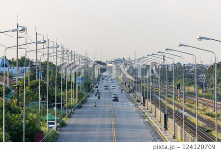 Aerial view of suburban traffic with multiple lanes, flow of traffic and the movement of cars, trucks and motorcycles. Transportation infrastructure articles. 124120709