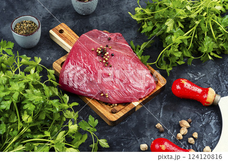 Raw beef steak on a rustic wooden board. 124120816