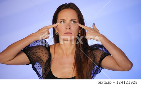 Beauty blogger pointing at under-eye wrinkles Beauty blogger pointing at under-eye wrinkles 124121928