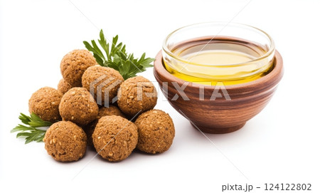 egyptian falafel served with tahini and olive oil, crispy golden chickpea fritters arranged on white background, traditional middle eastern cuisine concept of food, restaurant, catering 124122802