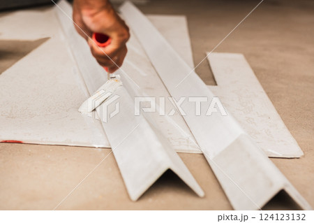 Painting a metal box for new roof by a roller painter Painting a metal box for new roof by a roller painter 124123132