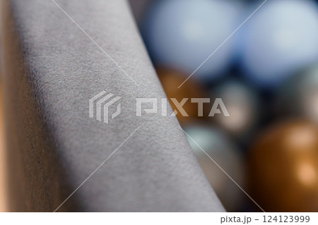 Close-up of Textured Grey Surface with Blurred Colorful Spheres in Background Close-up of Textured Grey Surface with Blurred Colorful Spheres in Background 124123999