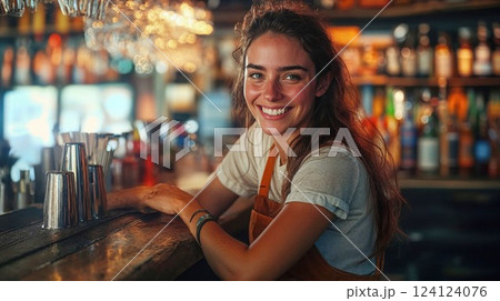 Cheerful female bartender in casual uniform smiling at camera. Young woman working at trendy pub with warm lighting and bokeh effects creating welcoming atmosphere Cheerful female bartender in casual uniform smiling at camera. Young woman working at trendy pub with warm lighting and bokeh effects creating welcoming atmosphere 124124076